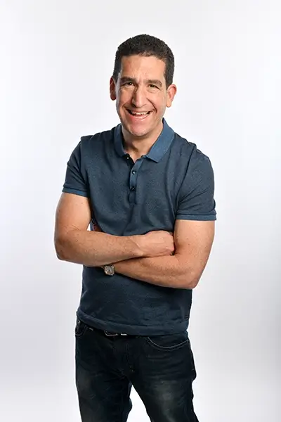 photo of Darren Altman smiling with arms folded against a white background.